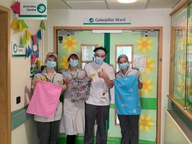 NHS staff with their new headbands and scrub washbags