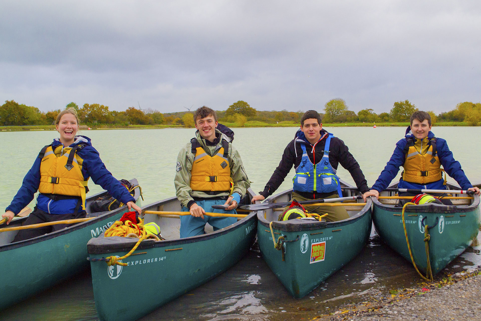 Outdoor Pursuits. Students in canoes, smiling