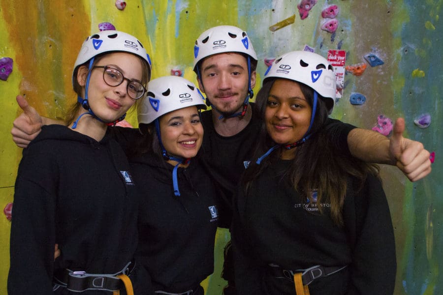 Public Services. Students at climbing wall, smiling