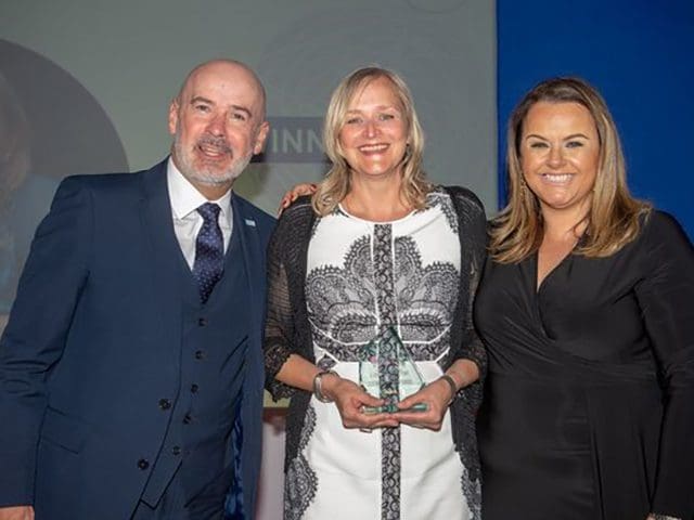 Clare Vertigen, Director of the South West Apprenticeship Company, smiles with two colleagues as she holds her award