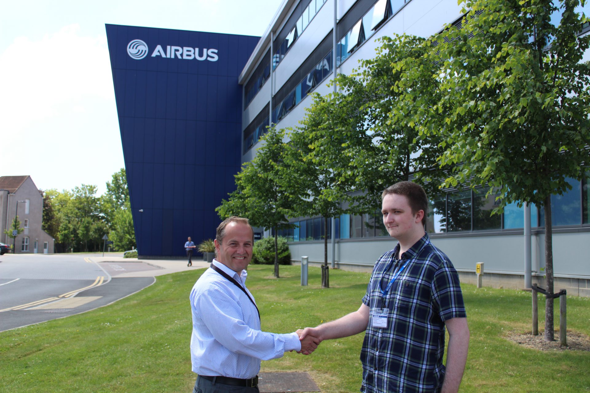Cameron Sidders, student, shakes hands with David Best, Head of Strategy & Business Development at Airbus
