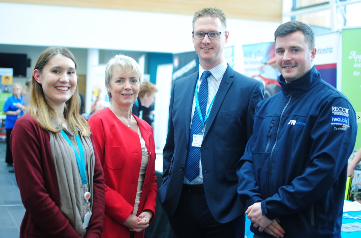 MP Karin Smyth, Lee Probert, Principal and Chief Executive for City of Bristol College, and two students stand in-front of a jobs fair displays
