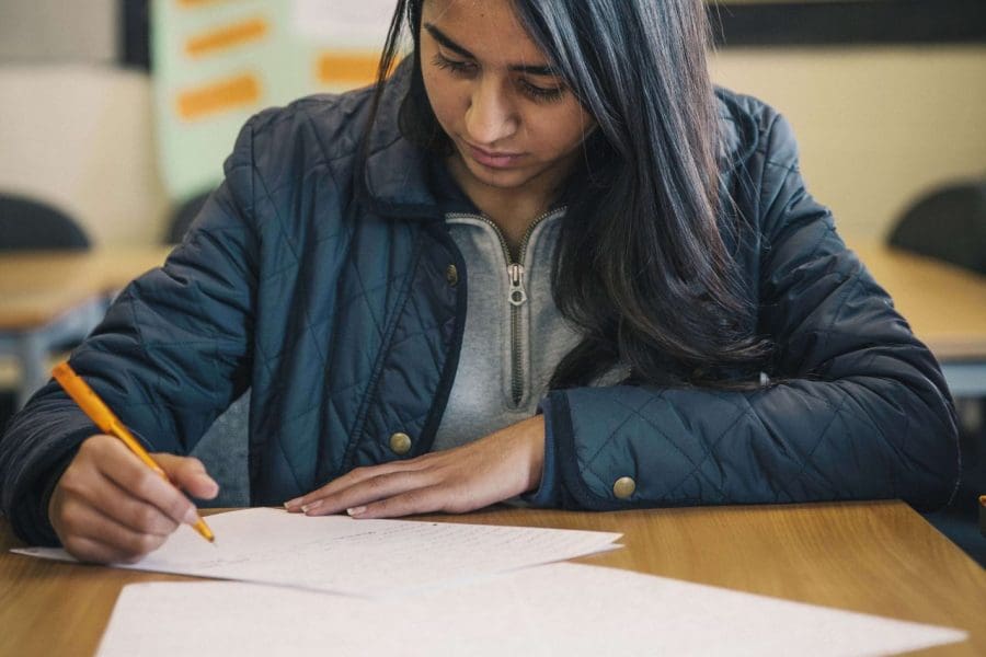 Law student, Aisha Rehman works in a classroom
