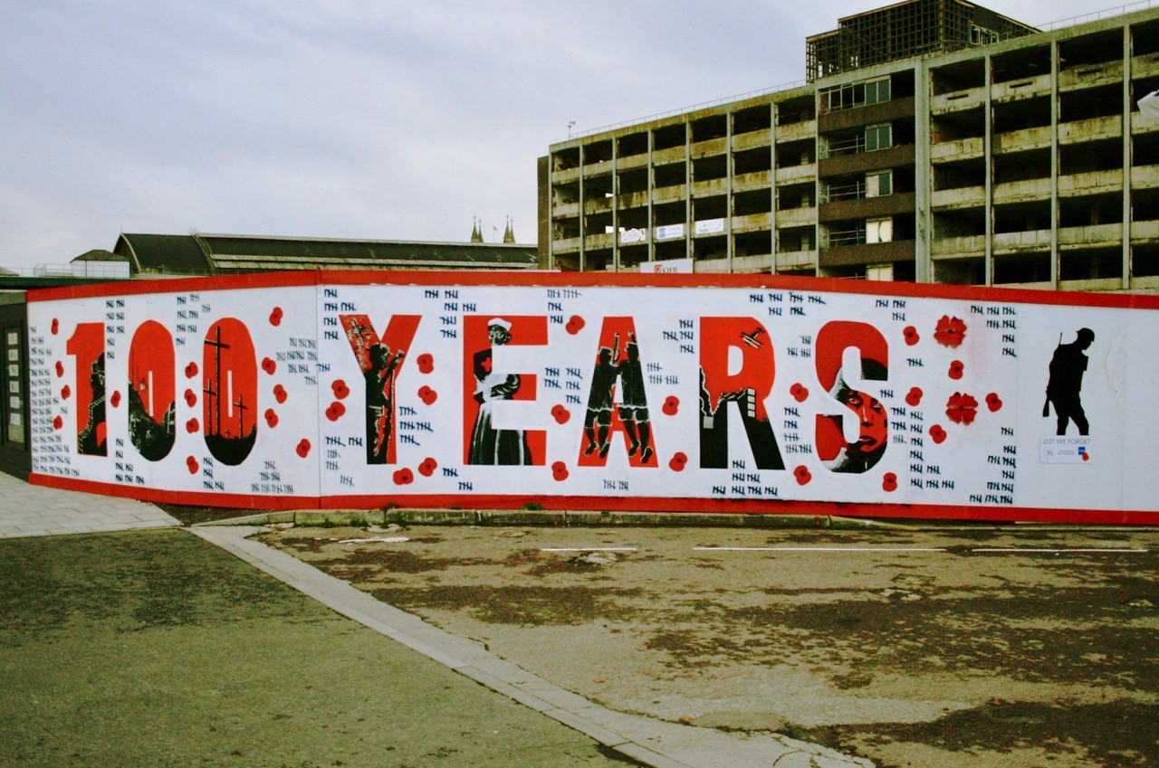 Mural commemorating 100 years the Armistance Centenary. "100 years" is written in bold red, surrounded by poppies and notches to indicate the death toll.