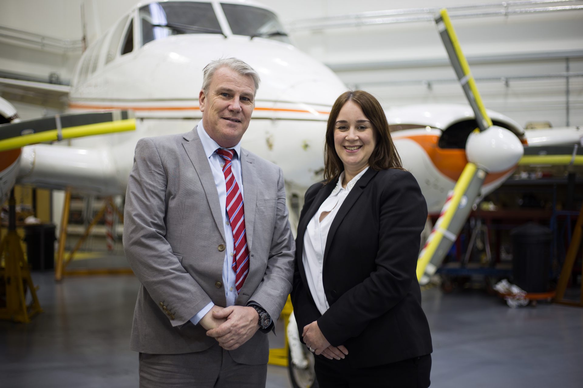 Richard Hyde, training leader, and Claire Thorogood, Director of Apprenticeships, at City of Bristol College standing infront of an airplane