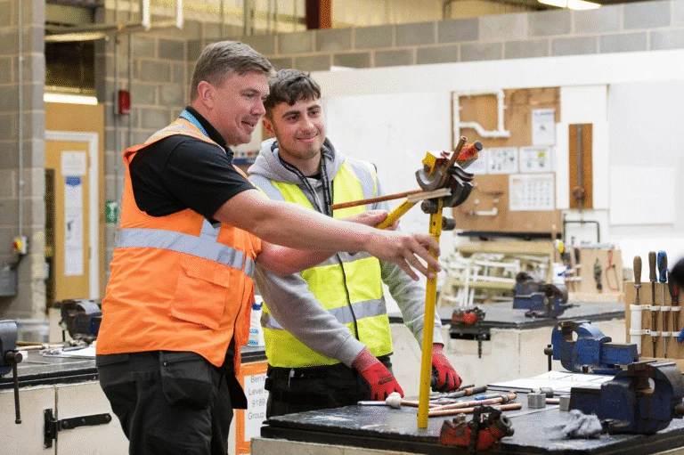 Construction teacher instructing a student.