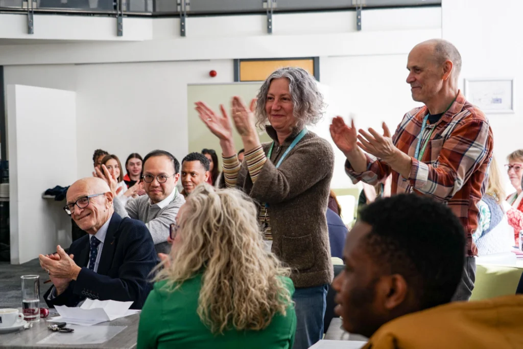 Members of staff clapping with happiness.