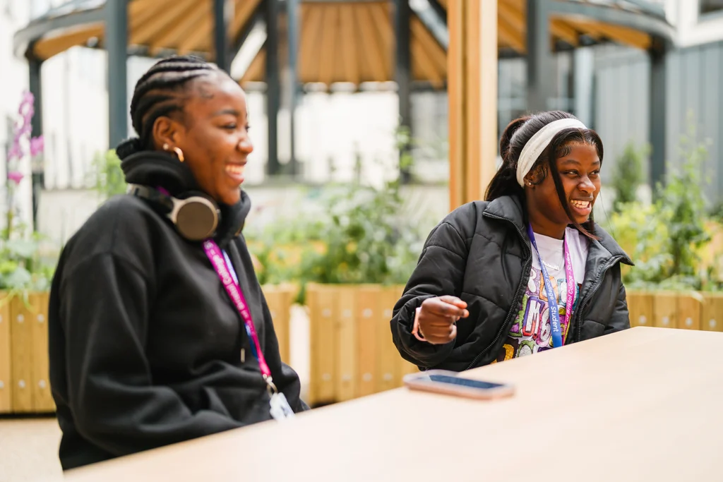 Students conversating in the College Green outdoor area