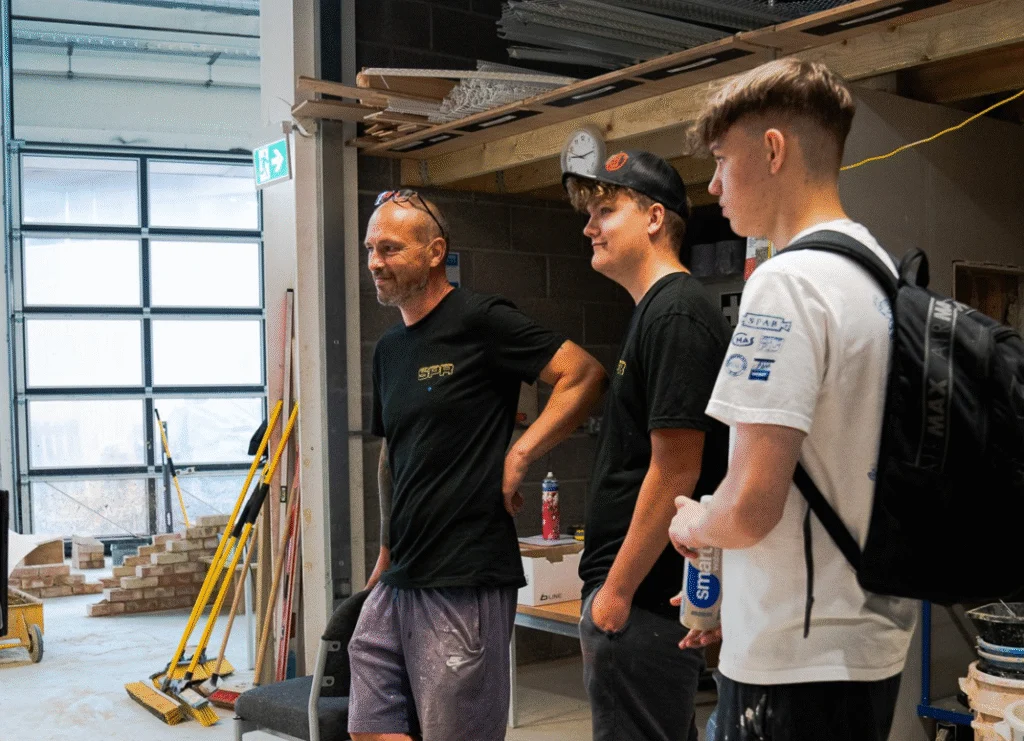 Three students listening to a talk