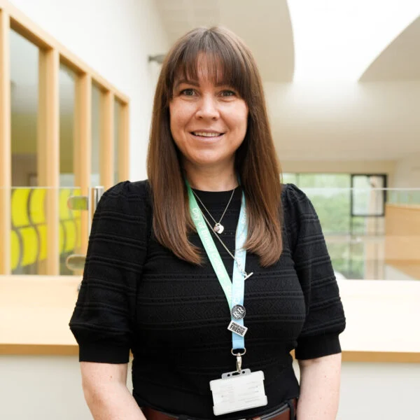 Member of staff stood smiling