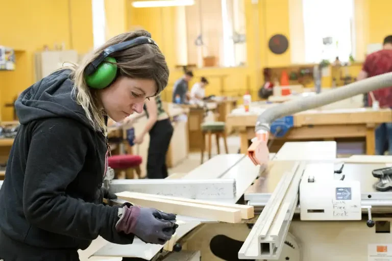 Female carpentry student working.