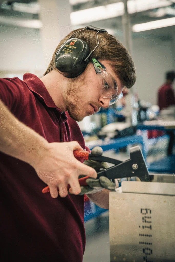 Engineering student using a tool.