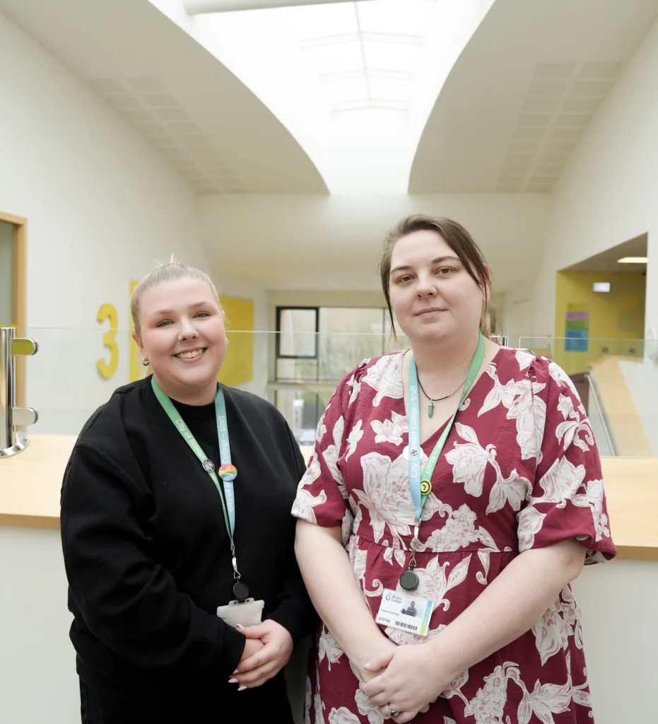 Two staff members smiling