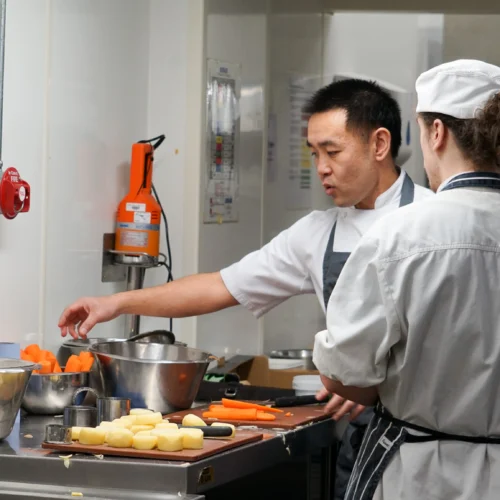 Catering and Hospitality Students pictured with a guest chef in the kitchen at the College Green Centre.