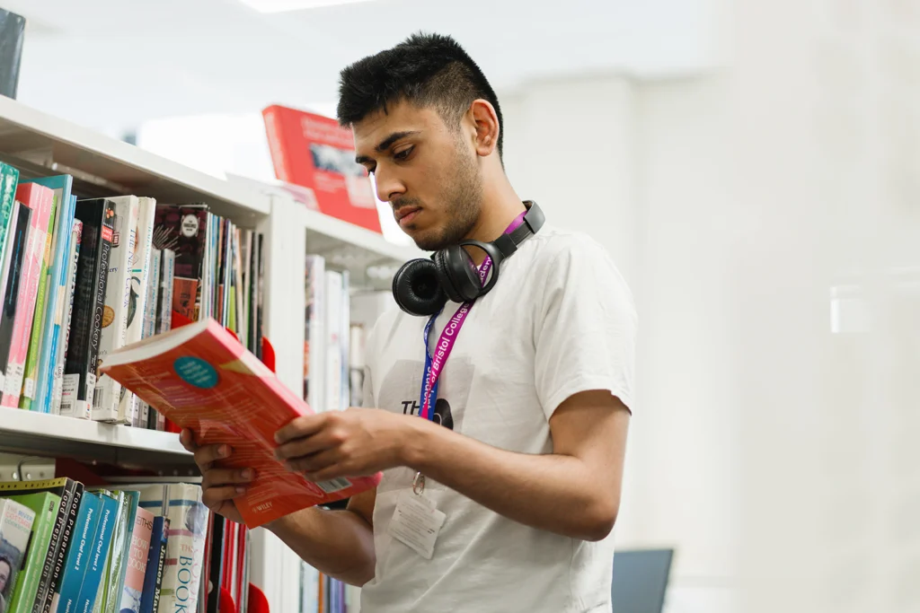 Student inside the library reading a book