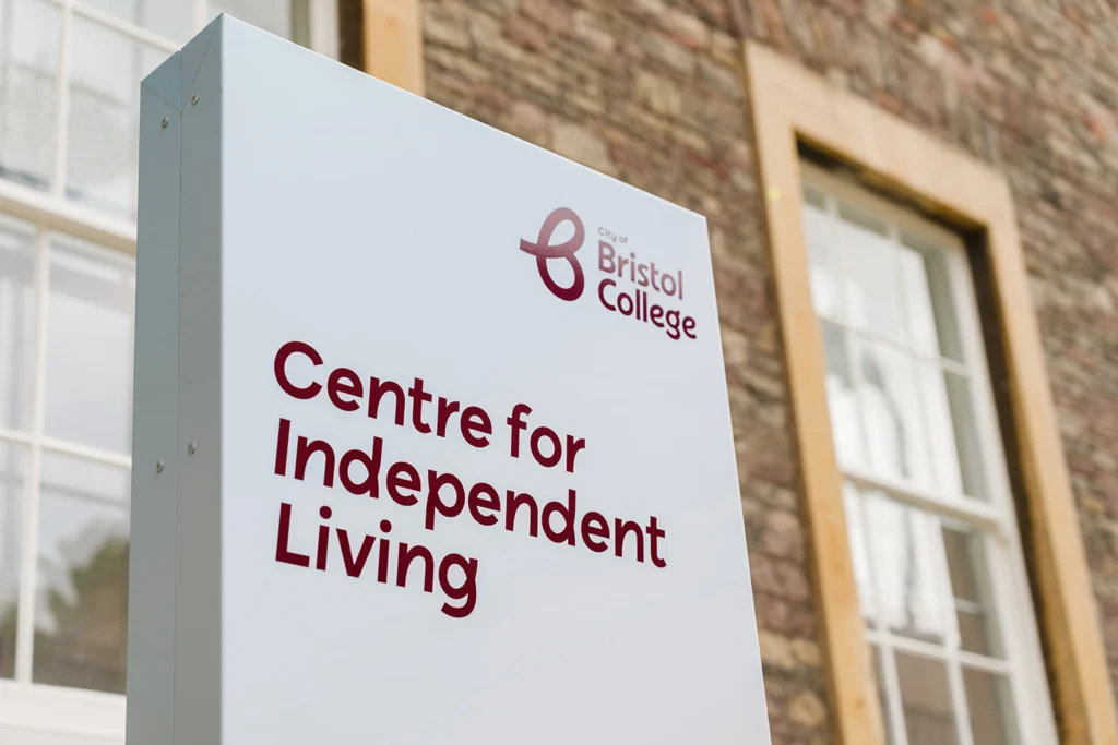 Closeup of signage that says Ashley Down Centre for Independent Living positioned in front of the actual building