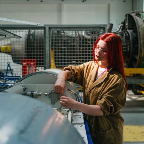 Female student checking aircraft