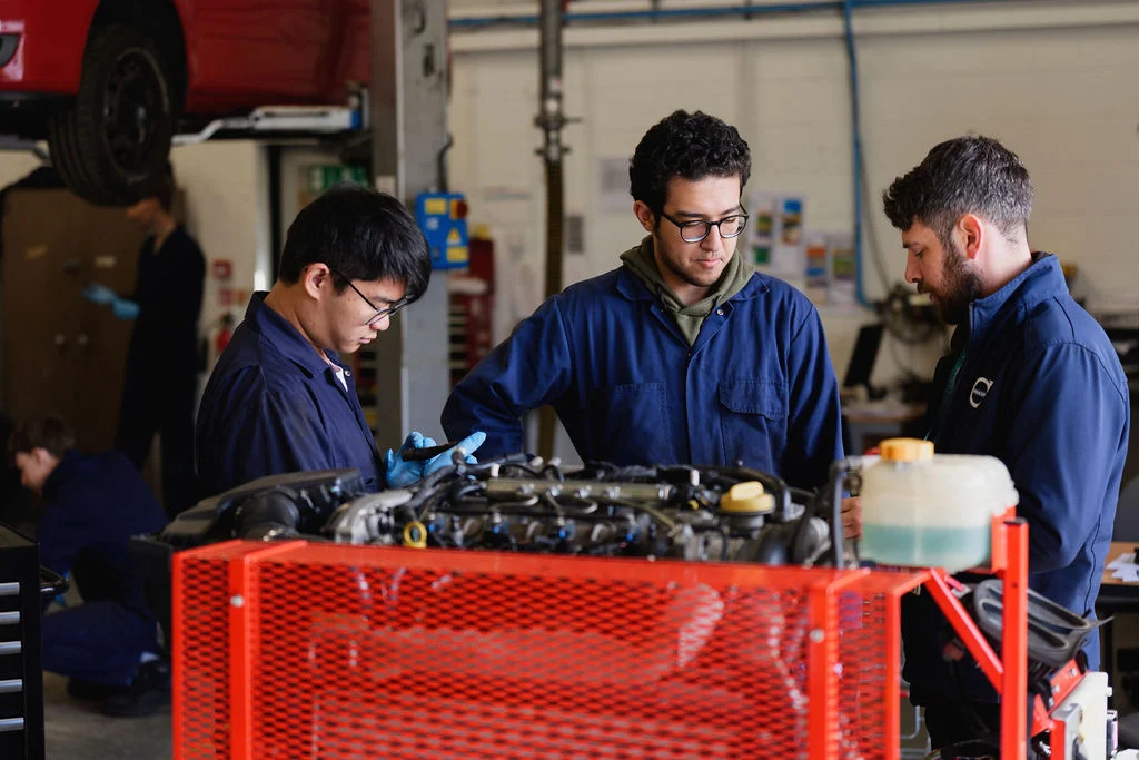 Students pictured with a lecturer in the Motor Vehicle workshop.