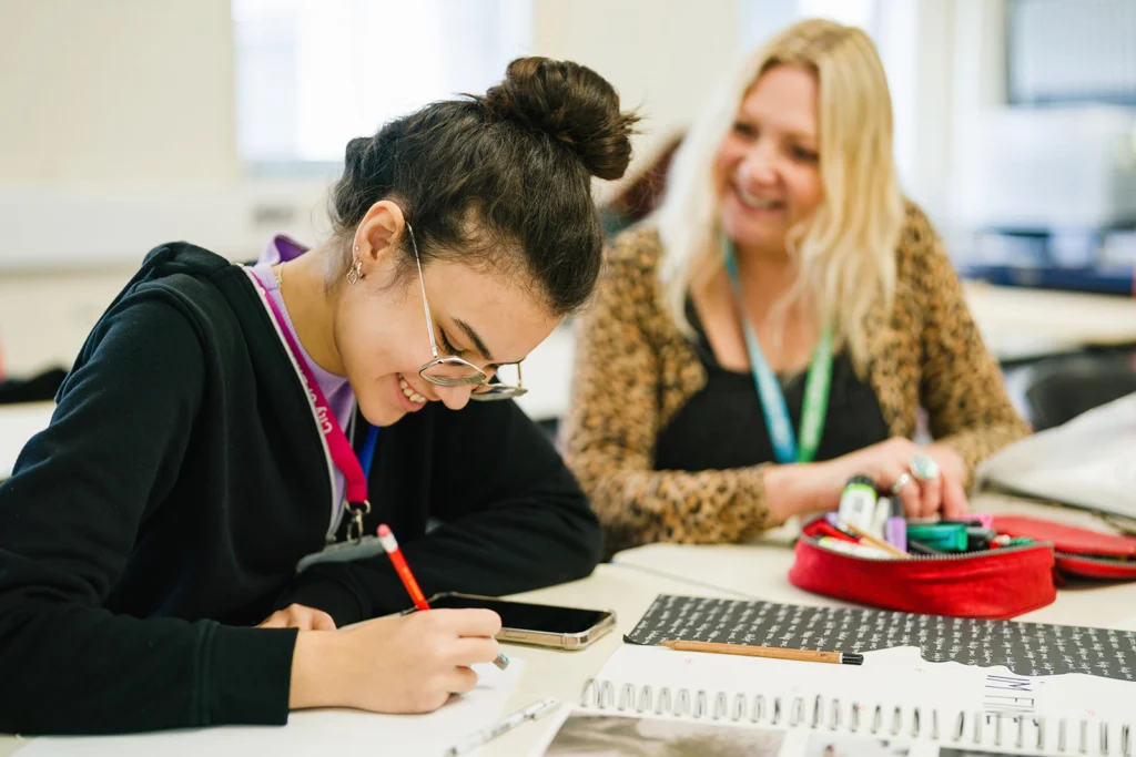 Student and teacher laughing