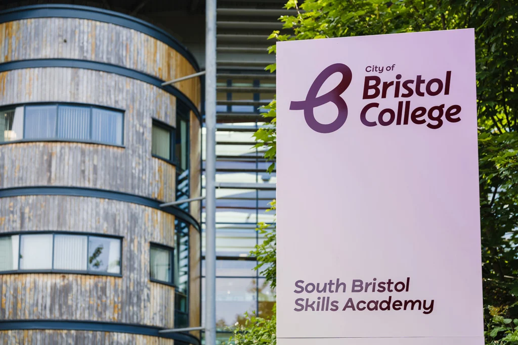 Image of signage for city of Bristol college with a modern building in the background