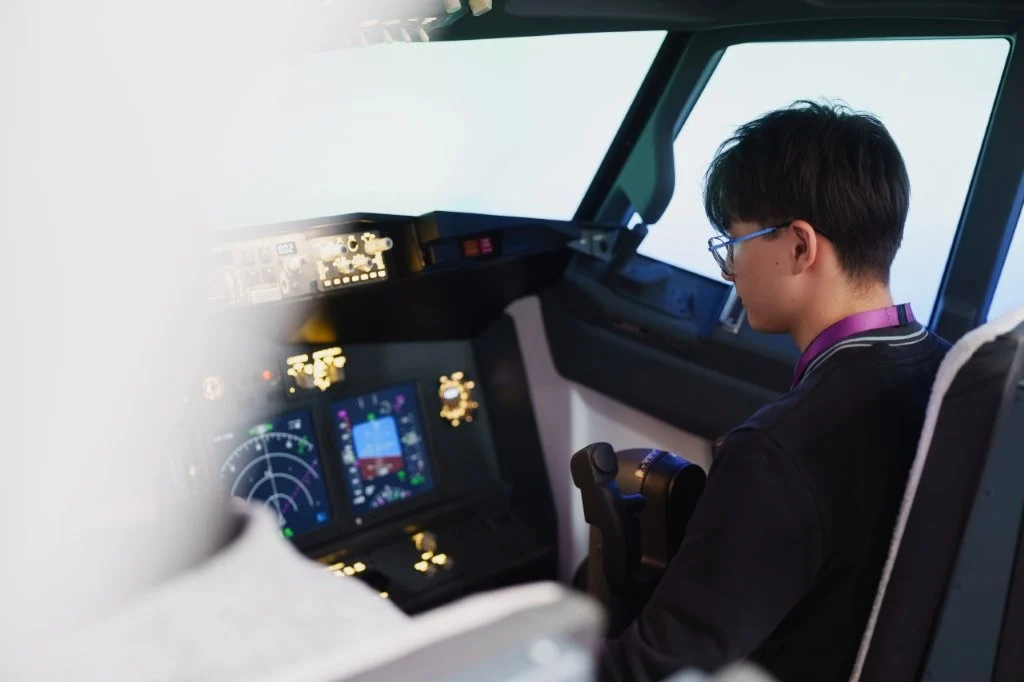 student in pilot simulator