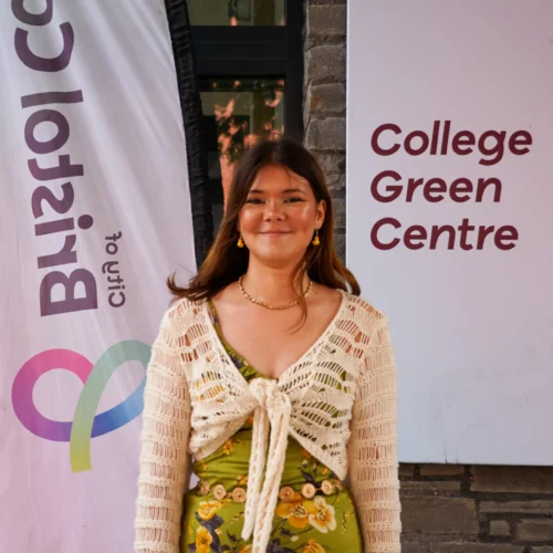 Student Freya standing in front of the main entrance at College Green Campus in Bristol.