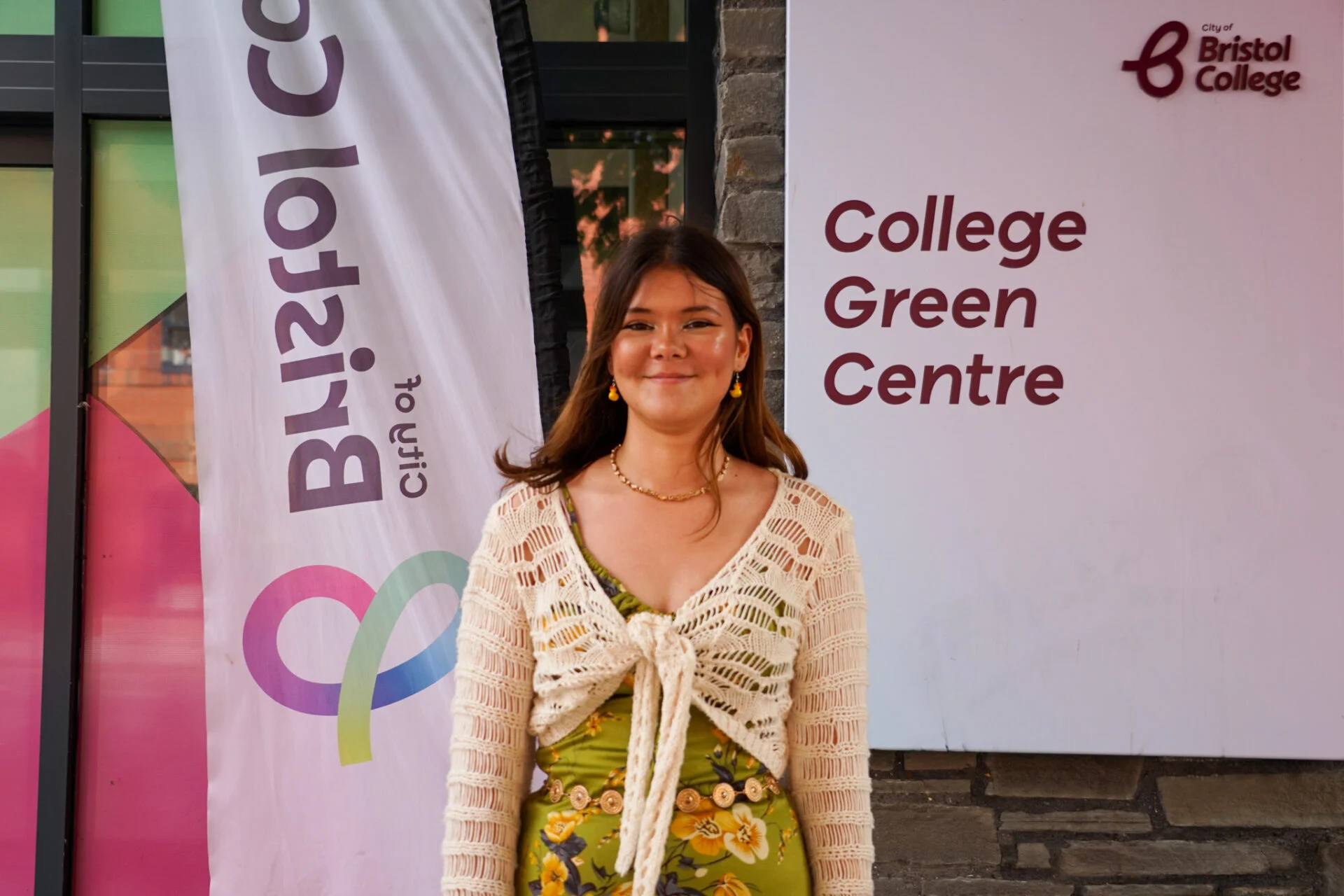 Student Freya standing in front of the main entrance at College Green Campus in Bristol.