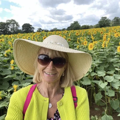 Jo Hampton, Floristry student pictured in a field of sunflowers.