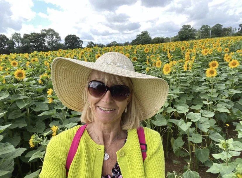 Jo Hampton, Floristry student pictured in a field of sunflowers.