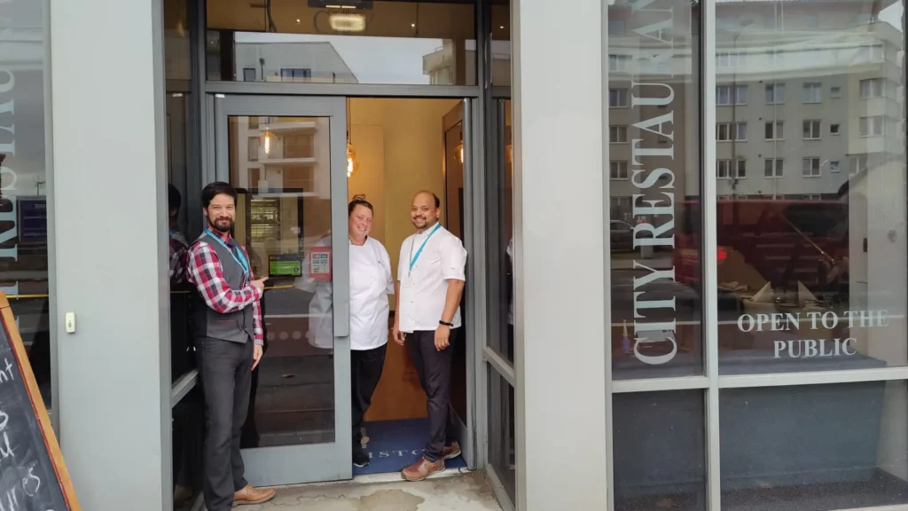 Restaurant staff open the doors of the city restaurant
