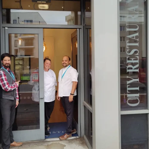 Restaurant staff open the doors of the city restaurant