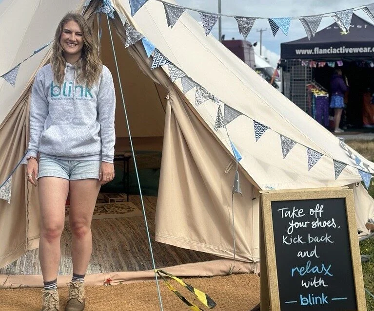 Marketing Officer, Abby, volunteering for blink mental health at a festival.