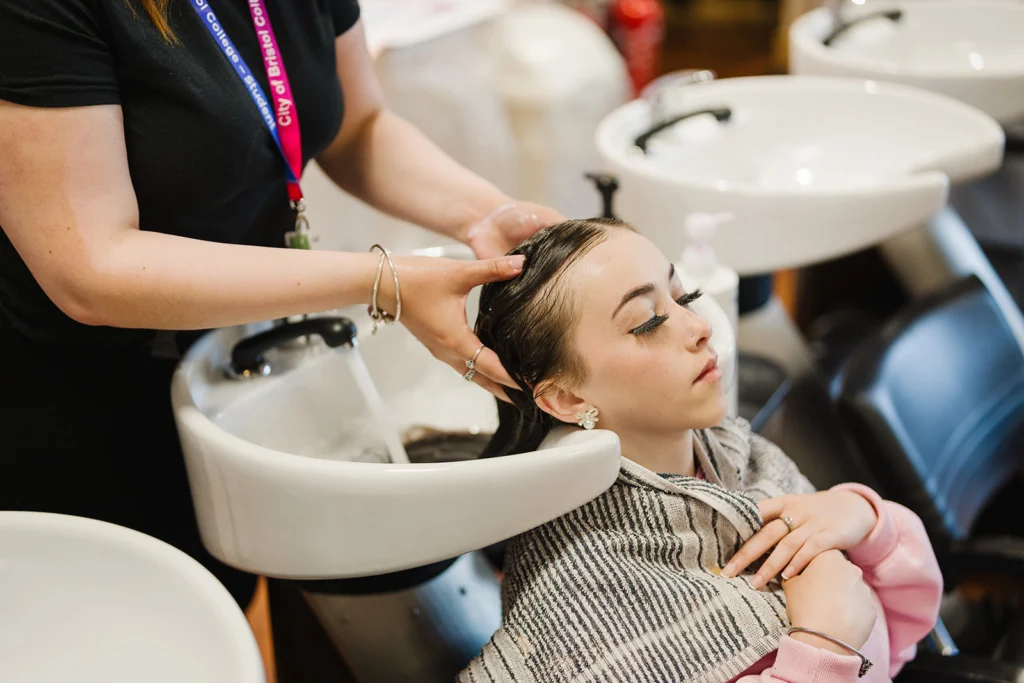 student cleaning another students hair