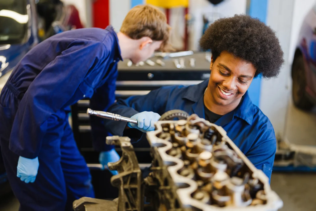 students working on car engine