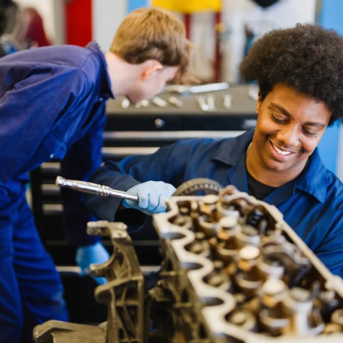 students working on car engine