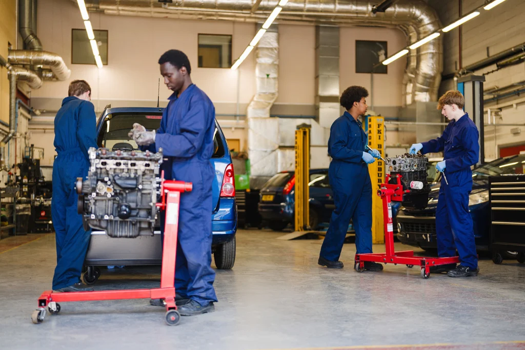 students in a car workshop