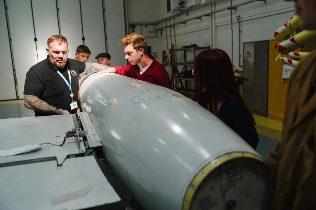 students replacing parts of an airplane