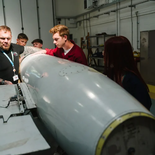 students replacing parts of an airplane