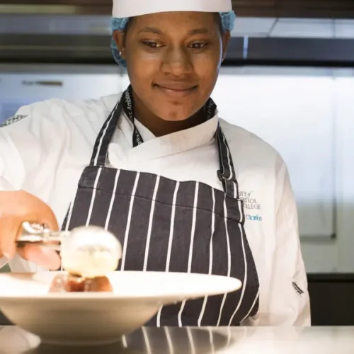 Catering and Hospitality student putting food on a plate