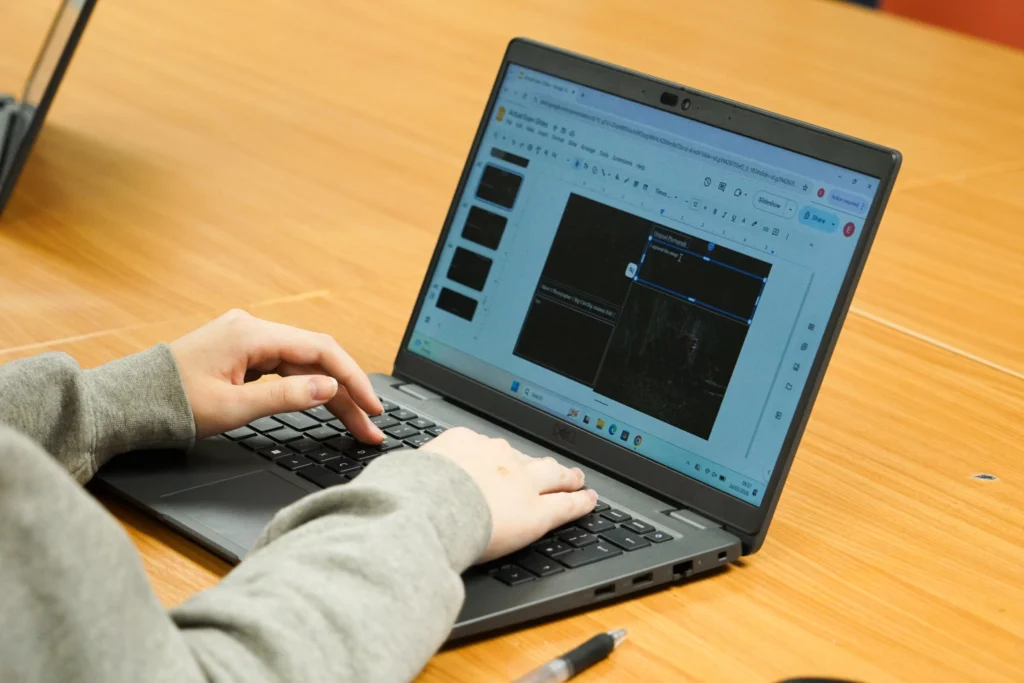 Student creating a presentation on the laptop