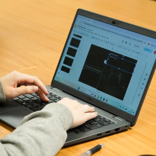 Student creating a presentation on the laptop
