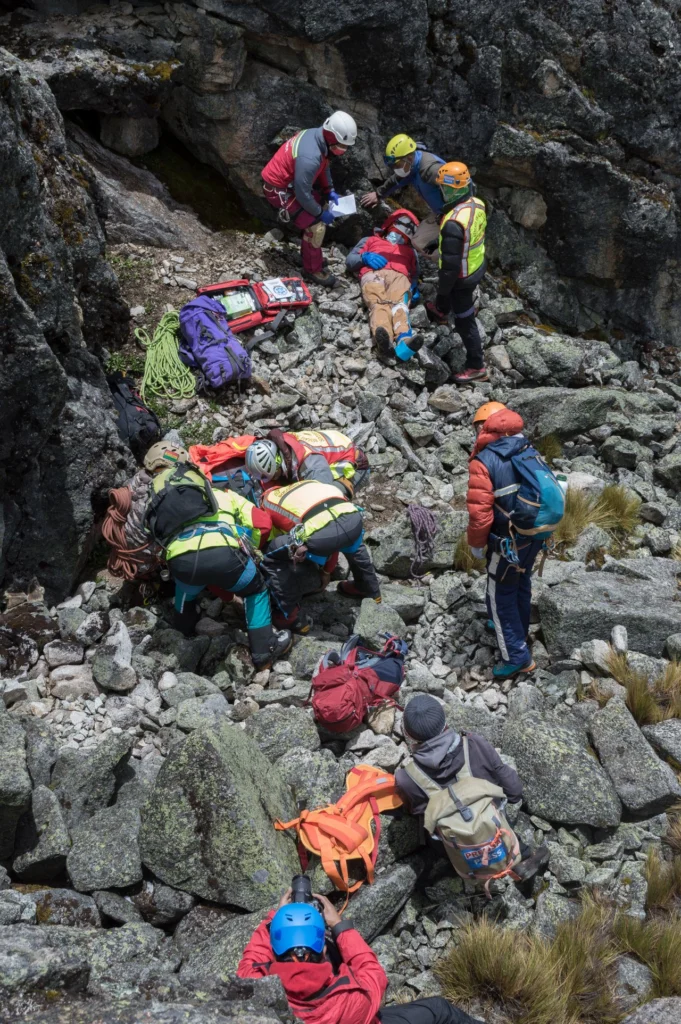 Mountain rescue team rescuing a person laying down