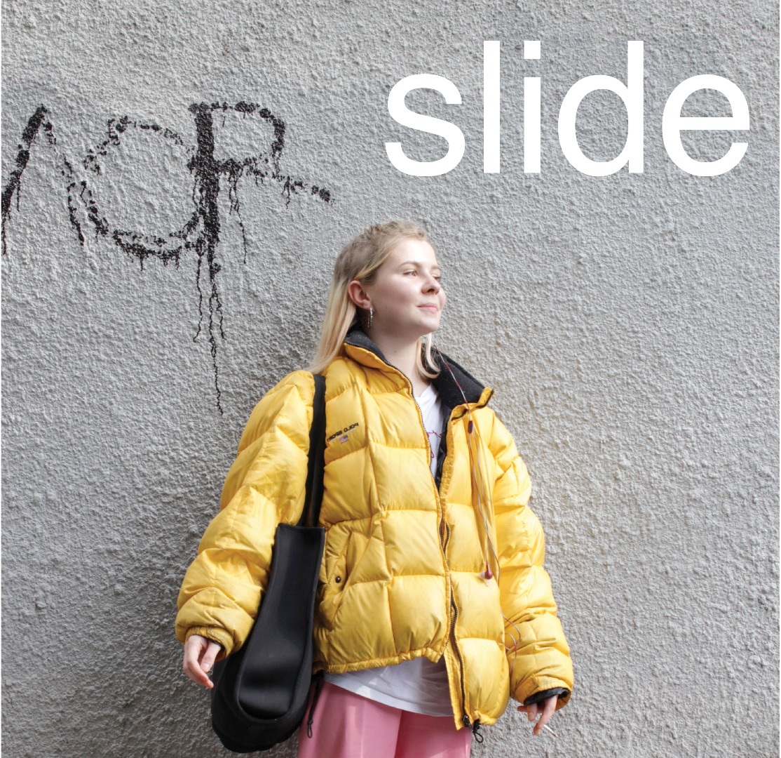 Poster for 'Slide'. A young woman is standing in-front of graffiti.